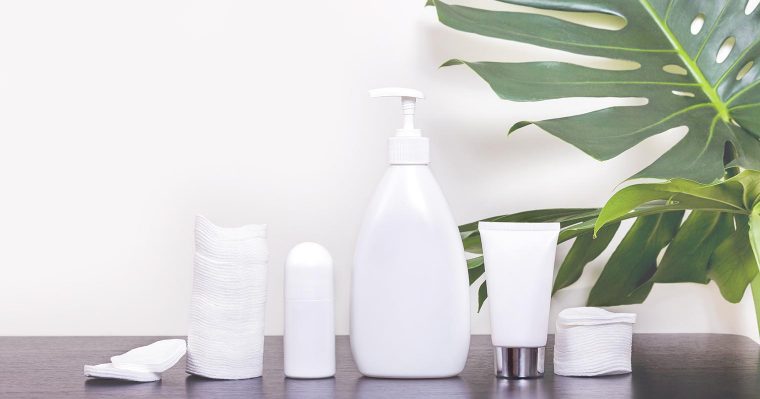 white bottles carrying skincare products