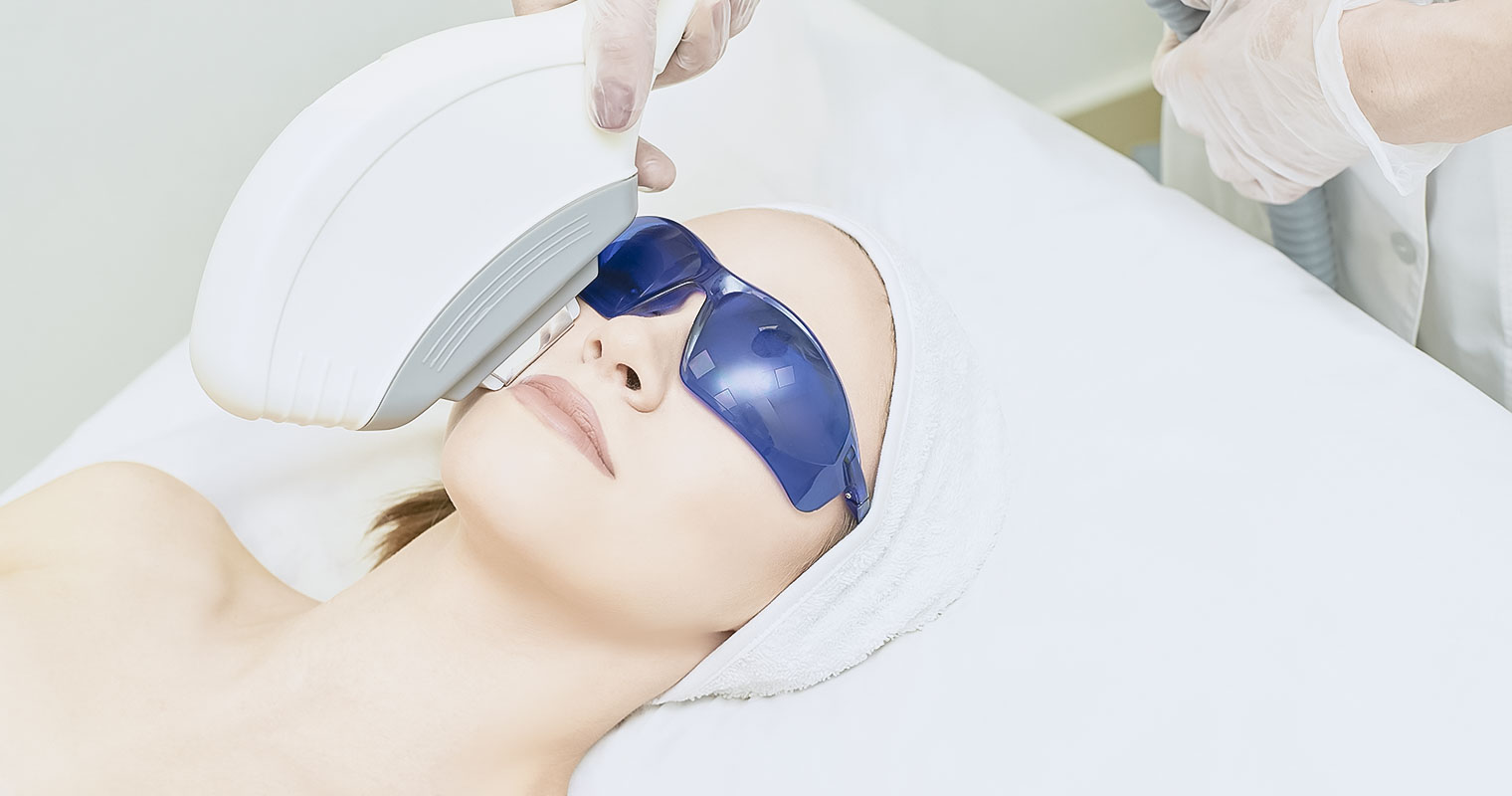 Woman going through laser treatment for the face