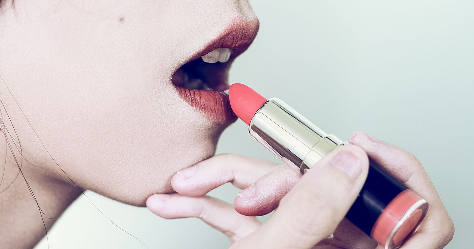 Woman applying lipsticks from the market may contain lead