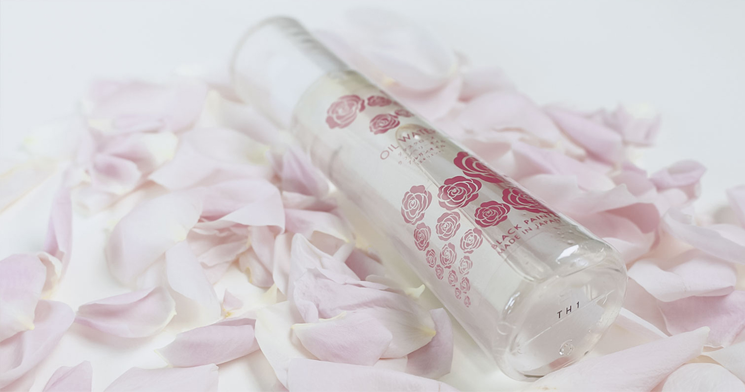 oil water rose bottle with rose petals