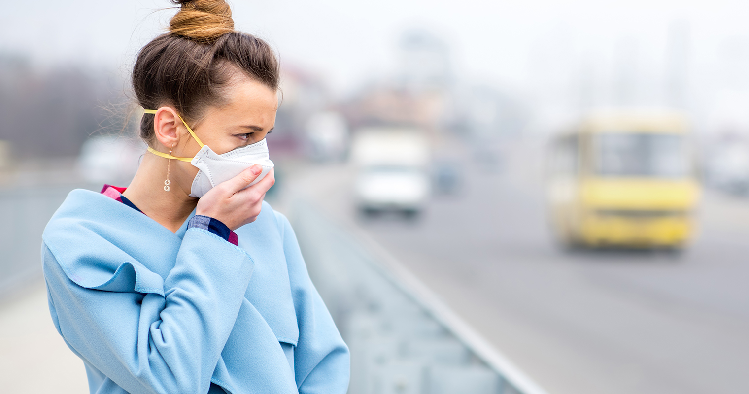 woman wearing a face mask to protect against air pollution and dust