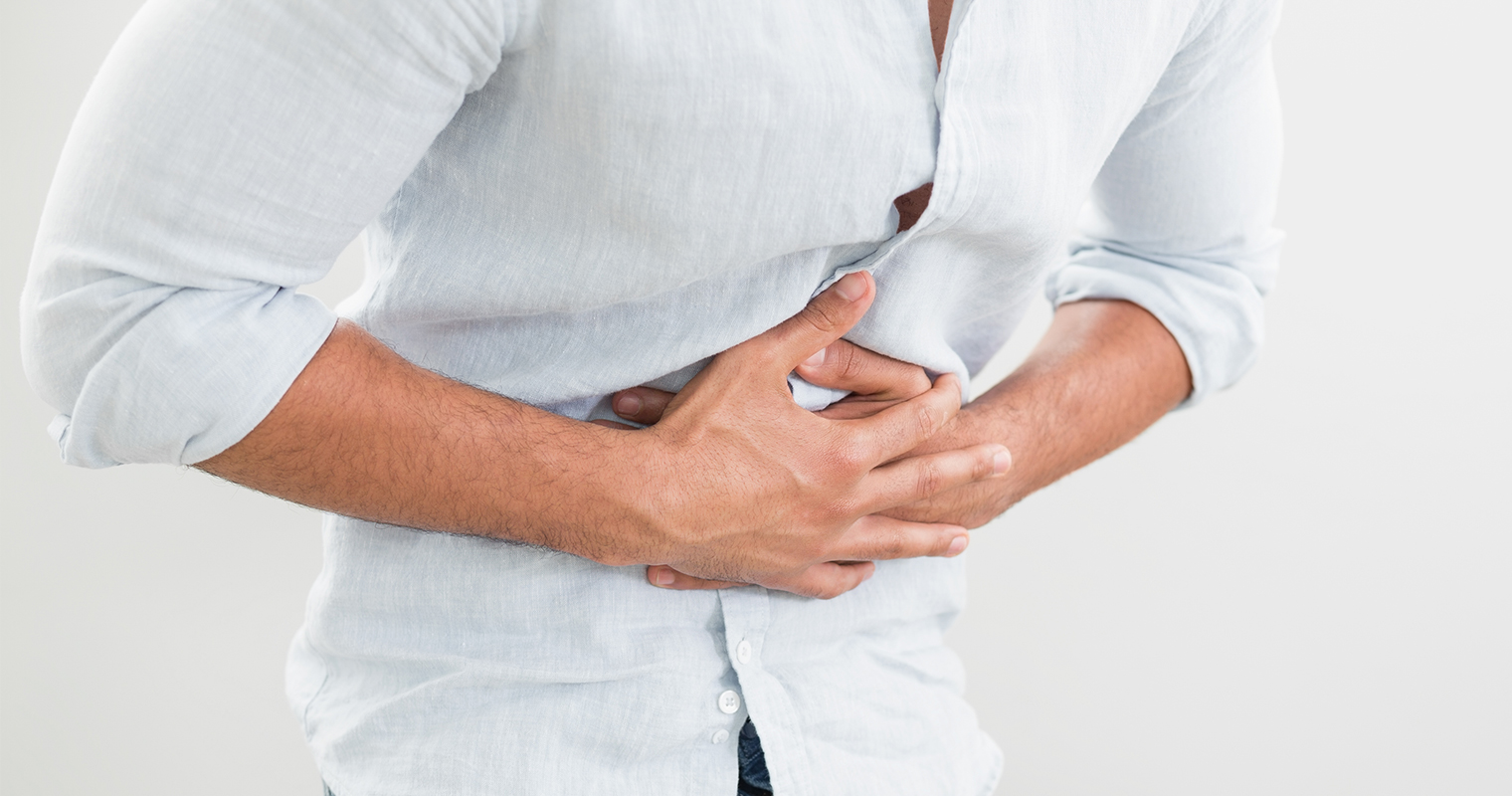 man suffering from tummy pain